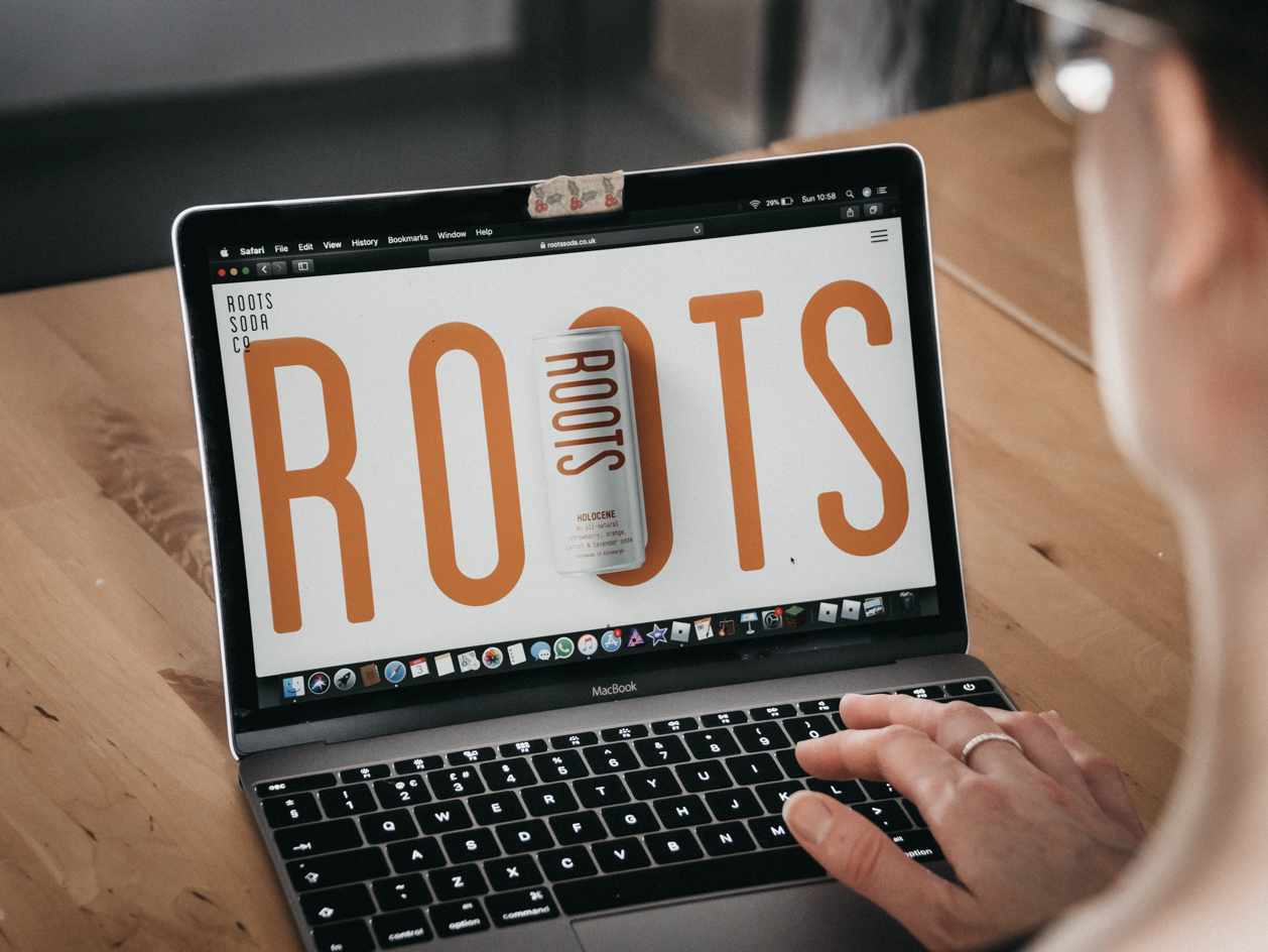 Roots Soda Co. website on laptop.